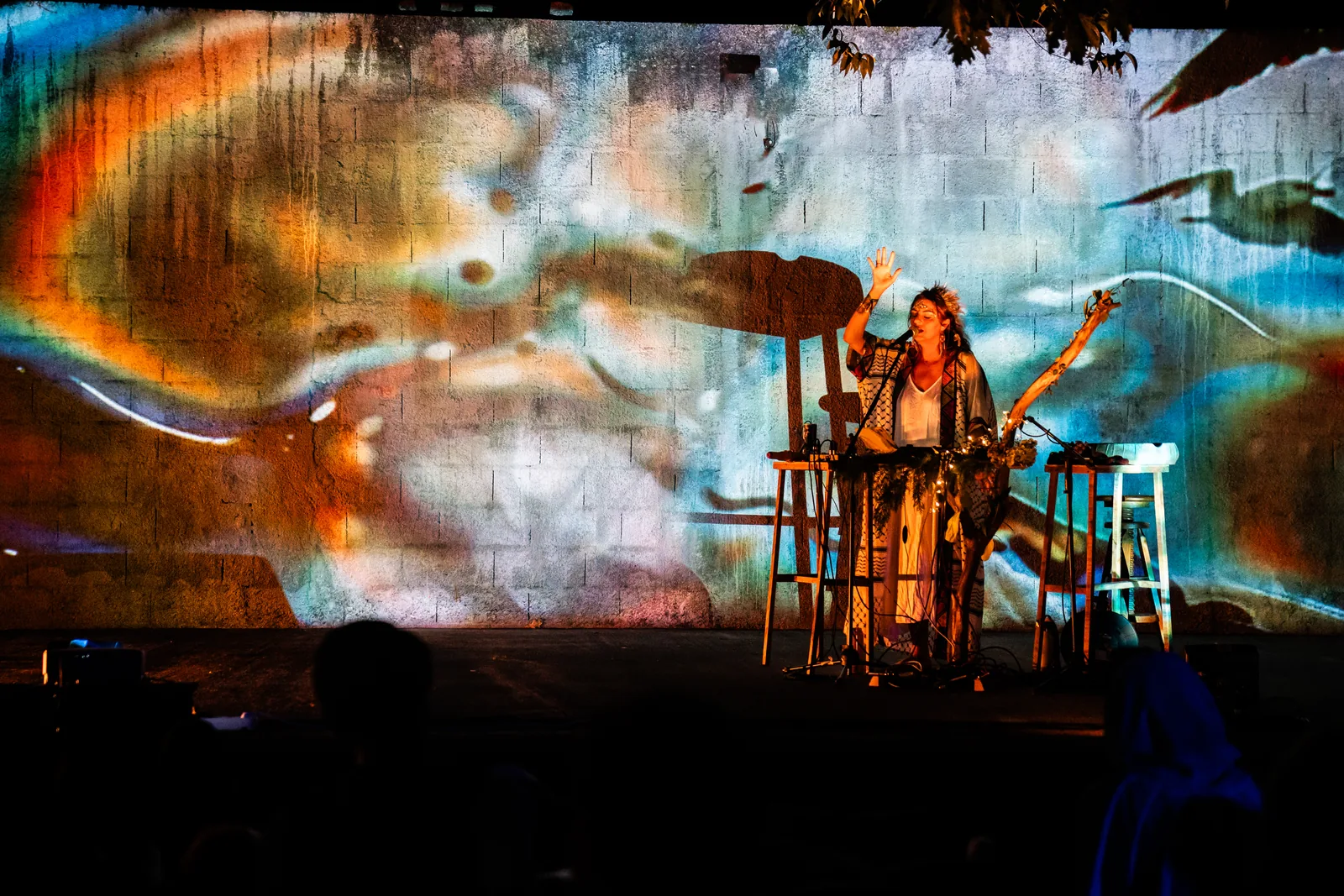 Rawan at her looping station beneath a vast projected painting, Synesthesia Festival, Portugal