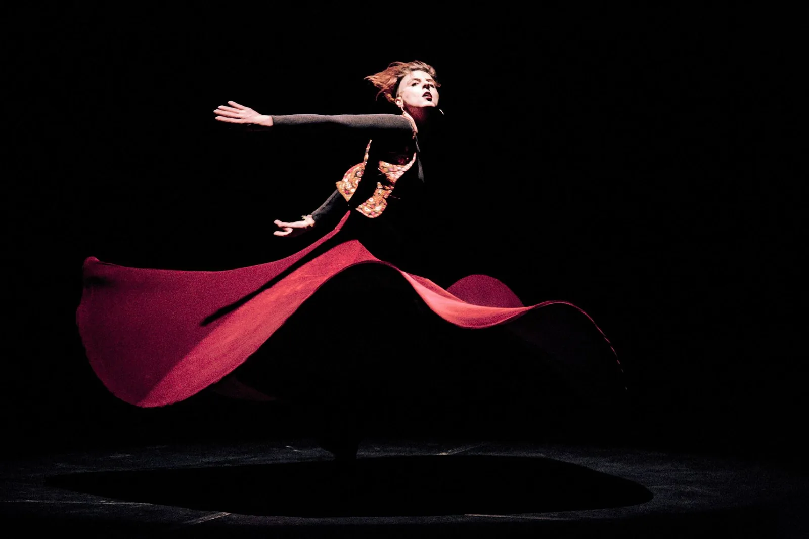 Rawan mid-turn, her skirt flying, at the opening of the Freedom Theatre Festival, Amman